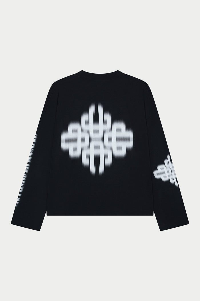Black long sleeved t-shirt with white geometric patterns on a light grey background